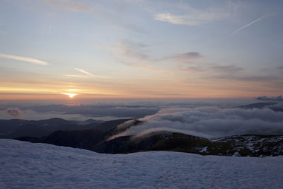 Scenic view of snow covered landscape against sky during sunset