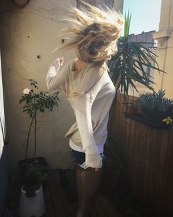 Woman shaking hair on balcony