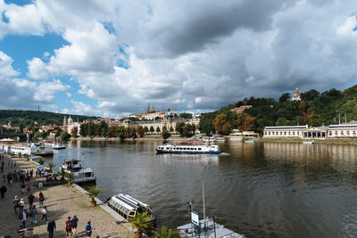 High angle view of boat on river against cloudy sky during sunny day