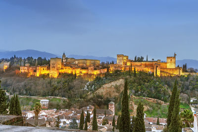 View of alhambra from st. nicholas church in evening, granada, spain