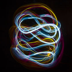 Close-up of light painting against black background