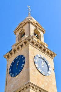 Low angle view of clock tower against sky