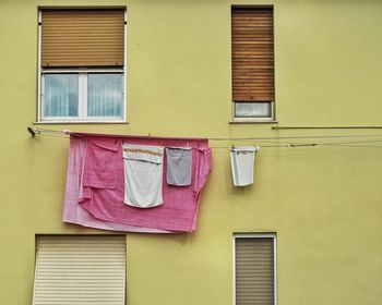 Low angle view of clothes drying against building