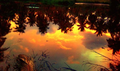 Scenic view of lake against orange sky