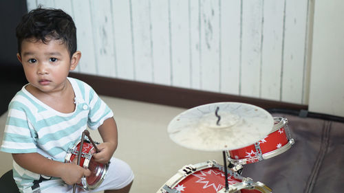 Cute boy playing with toy at home