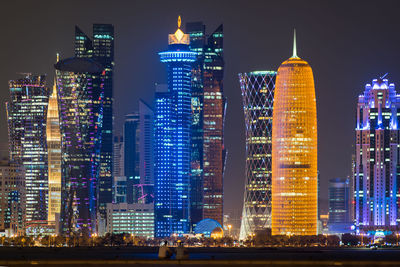 Illuminated buildings in city at night