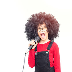 Portrait of smiling young woman against white background