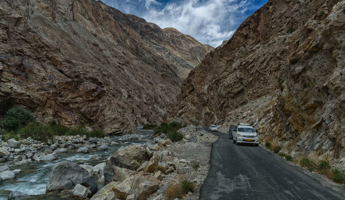 Road amidst rocks against mountains