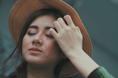 Close-up of woman wearing hat at city