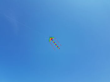 Low angle view of airshow against clear blue sky