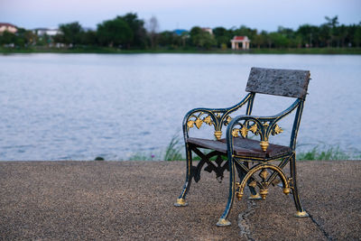 Empty bench by lake