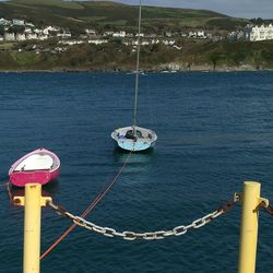 Sailboat moored in sea