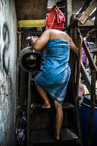 Rear view of woman walking on steps