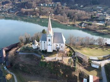 High angle view of buildings by lake in town