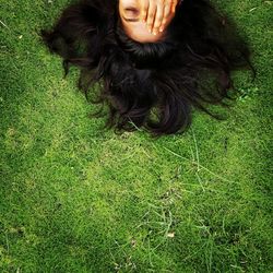 High angle portrait of woman relaxing on field