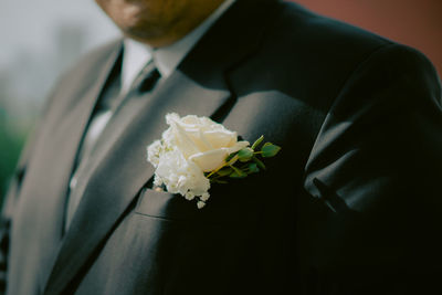 Midsection of bride holding bouquet