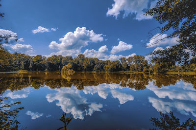 Reflection of trees in lake against sky