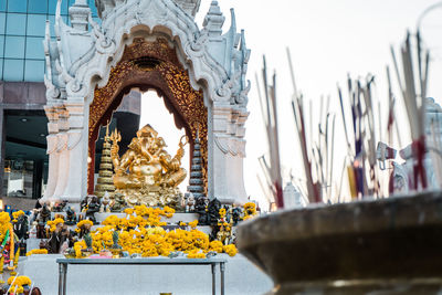 Statue in temple by building in city