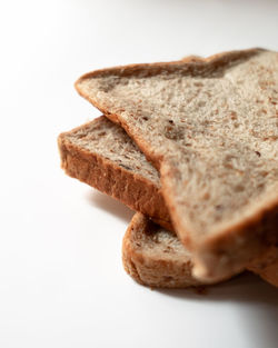 Close-up of bread against white background