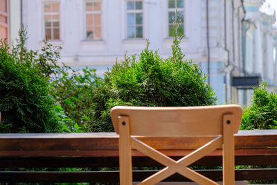 Defocused photo of bar stool back and counter against blurred cityscape background. 