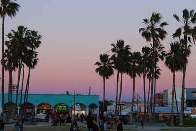 People at beach during sunset