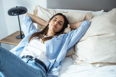 Young woman sleeping on bed at home