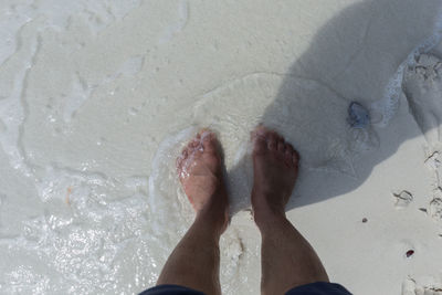 Low section of person on sand