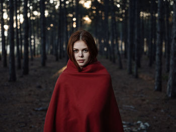 Portrait of woman standing in forest