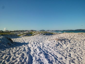 Scenic view of land against clear blue sky