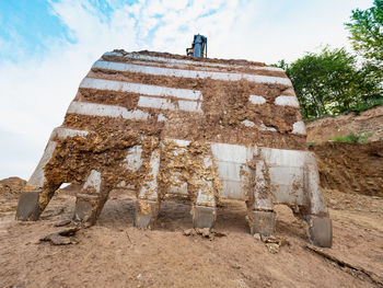 Industrial toothed digger bucket bite the ground. loader constraction excavator bucket close up.