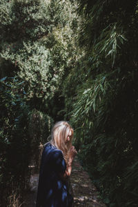 Woman standing in forest