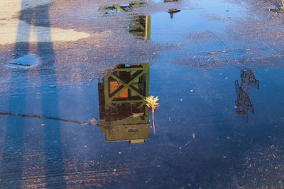 Reflection of building on puddle