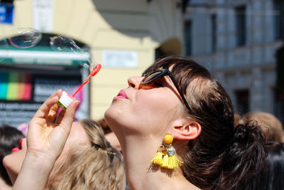 Portrait of woman holding ice cream outdoors