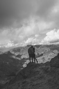 Man standing on mountain against sky