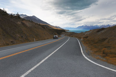 Road amidst mountains against sky