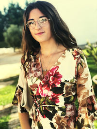 Portrait of smiling young woman standing outdoors