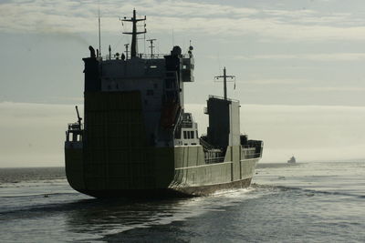 Ship sailing on sea against sky