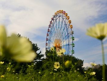 Low angle view of ferris wheel against sky