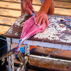 Cropped hand of man working on wood