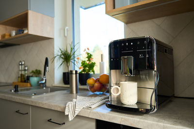 Interior of kitchen with modern coffee maker on countertop