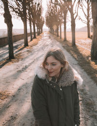 Portrait of smiling woman standing in snow