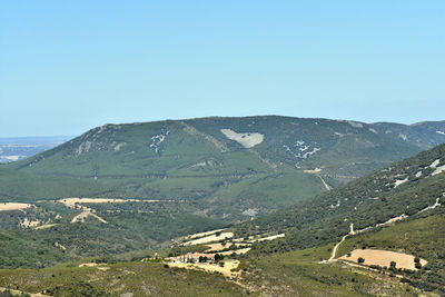 Scenic view of mountains against clear blue sky