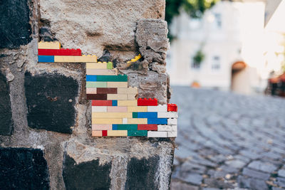 Wall on street repaired with plastic toy blocks