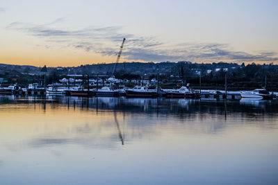 Boats in lake at sunset