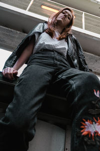 Low angle view of woman sitting on floor