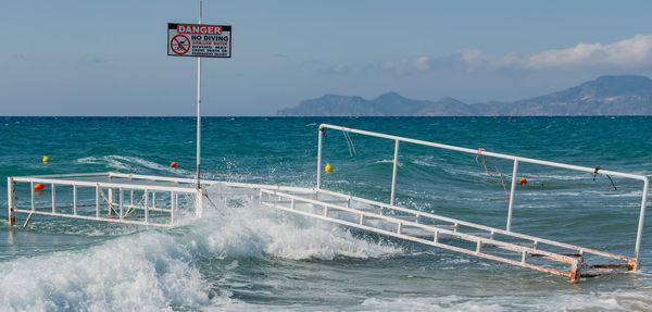 Broken bathing place with waves overflowing in storm in the mediterranean, on kos greece