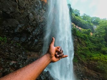 Midsection of waterfall against rocks