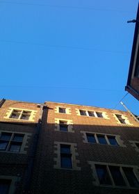 Low angle view of building against blue sky