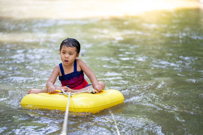 Active little girl playing at mountain stream