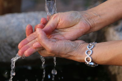 Close-up of hands holding water